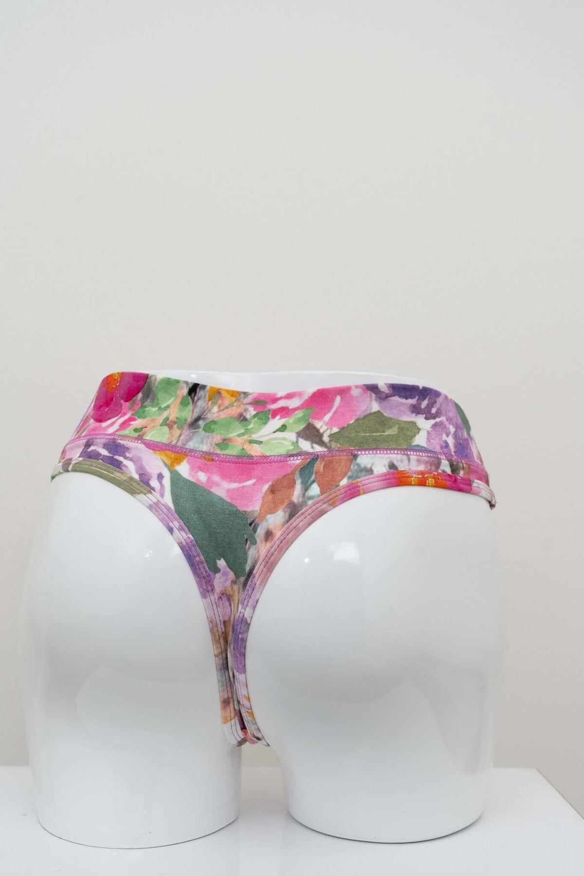 Back view of high rise floral bamboo thong on display mannequin