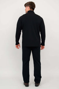 Back view of man in black bamboo fleece zip-up jacket