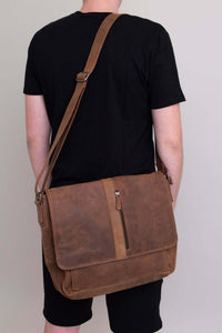 Man from behind showing brown buffalo leather messenger bag with long shoulder strap