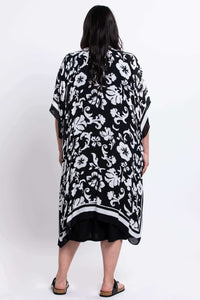 Back view of model displaying the pattern of the black floral kimono wrap