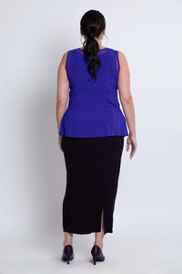 Back view of model wearing purple mesh tank top and black skirt