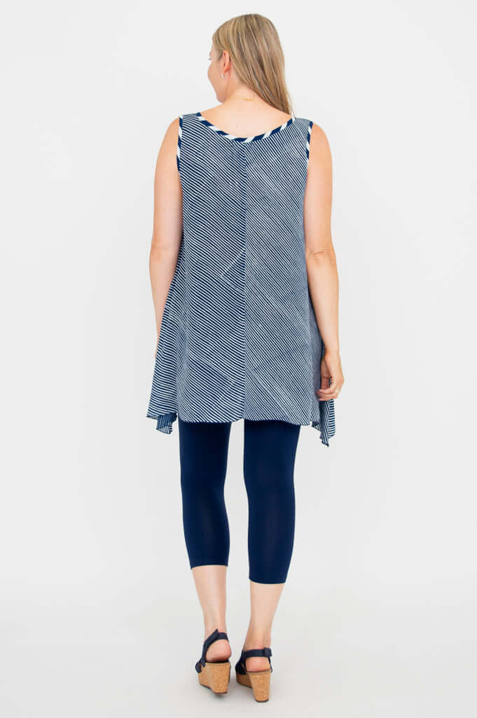 Back view of a woman wearing the navy stripe swing tank top and navy leggings