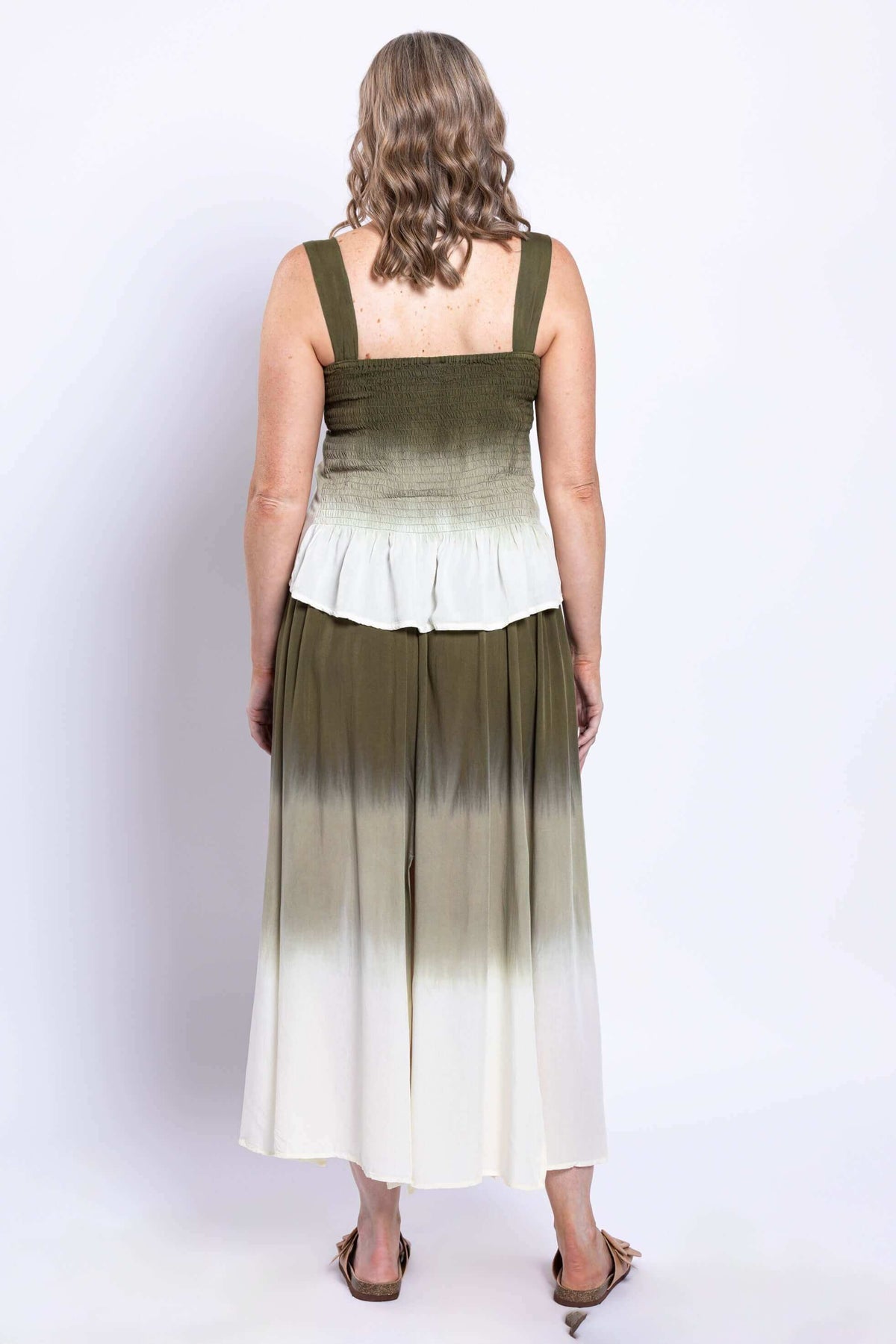 Back view of a woman wearing an olive ombre maxi skirt and matching top.