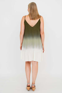Back view of woman wearing olive ombre mini dress with V-back and flounce hem