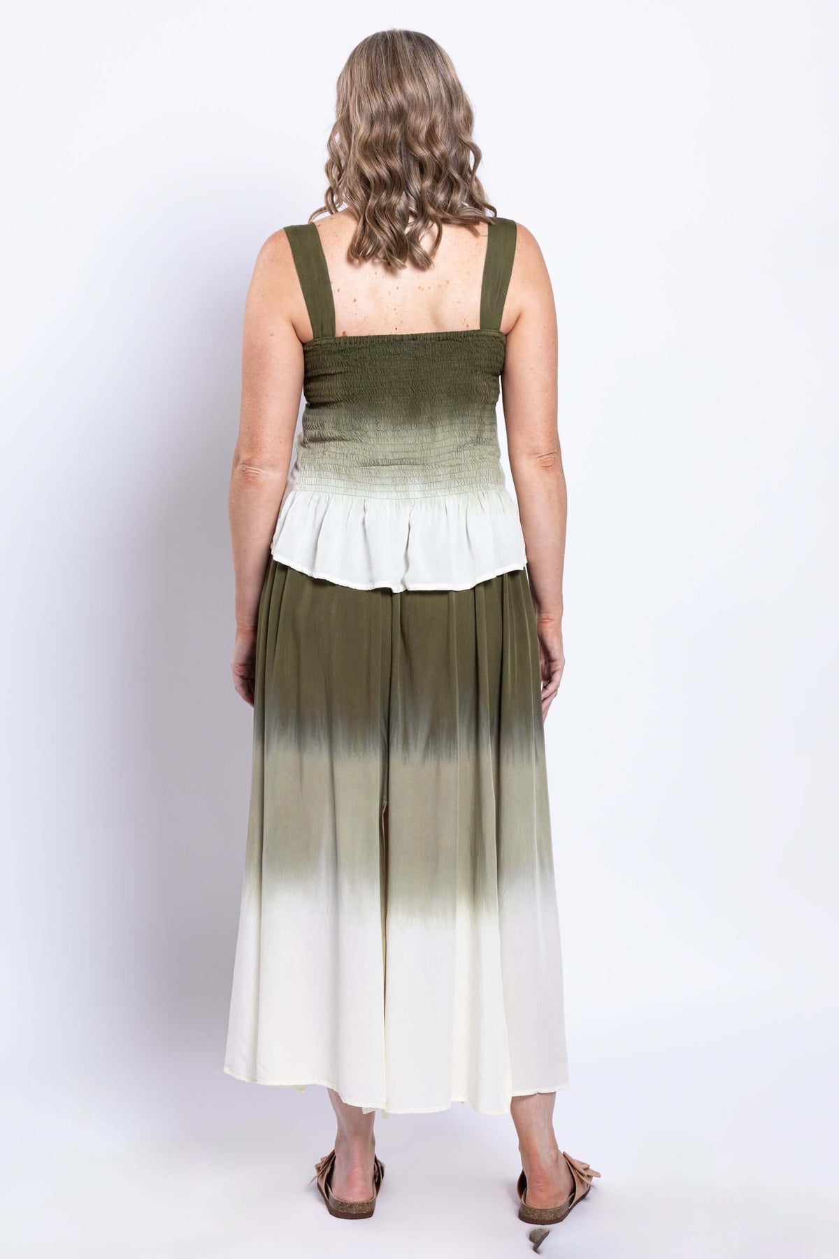 Back view of olive ombre sleeveless tank top and matching skirt worn by a woman