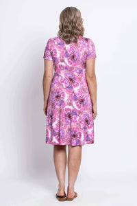 Back view of woman in a pink and purple floral bamboo knee-length dress