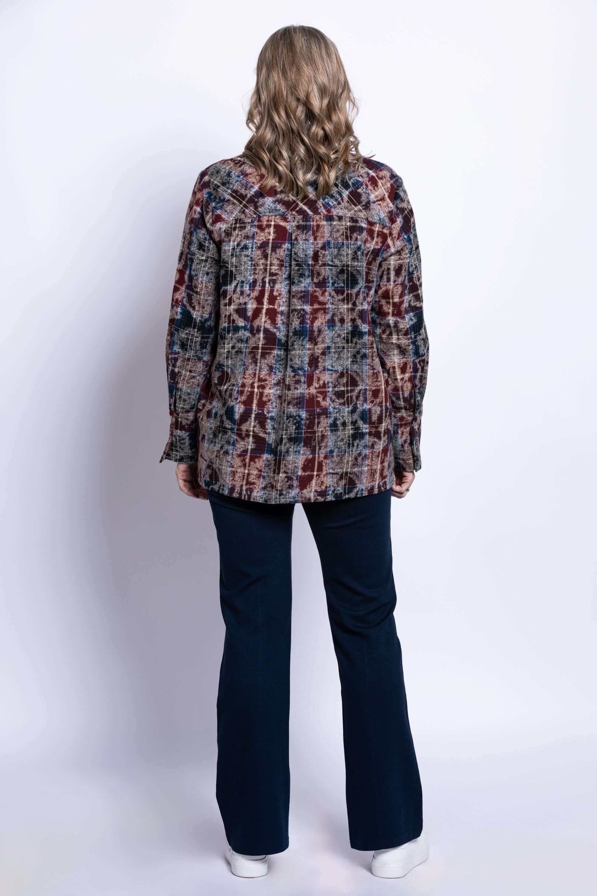 Back view of a woman wearing a plaid cotton jacket with long sleeves