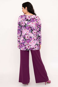 Back view of model in purple floral tunic and wide-leg purple pants