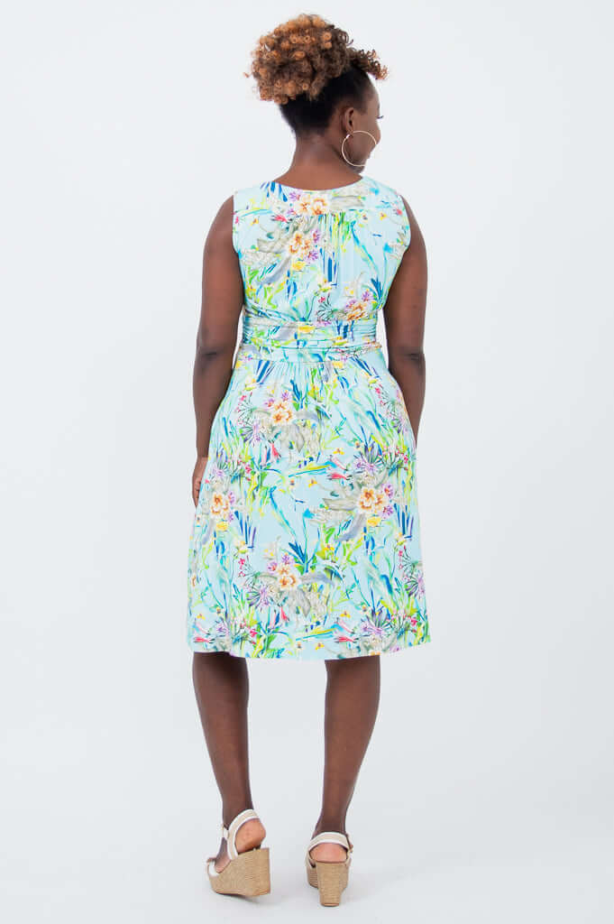 Back view of sleeveless blue floral ruched dress with pockets