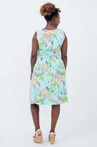Back view of sleeveless blue floral ruched dress with pockets