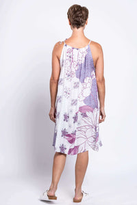 Back view of a woman in a purple and white floral sleeveless knee-length summer dress