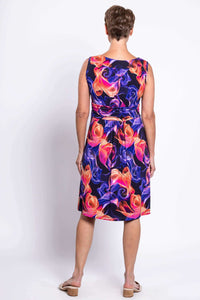 Back view of woman in sleeveless dress with colorful swirl print