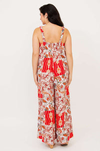 Back view showing strappy detail of the red and cream patchwork jumpsuit