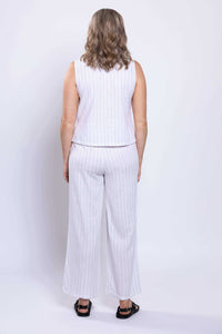 Rear view of woman wearing white striped linen tank and wide-leg pants