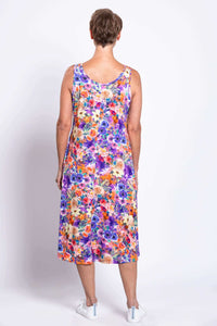 Back view of a woman wearing a colorful floral tank dress showing full coverage