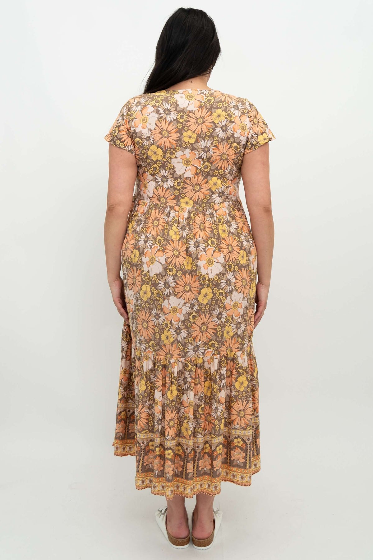 Back view of woman in floral Sharpie dress showing tiered details