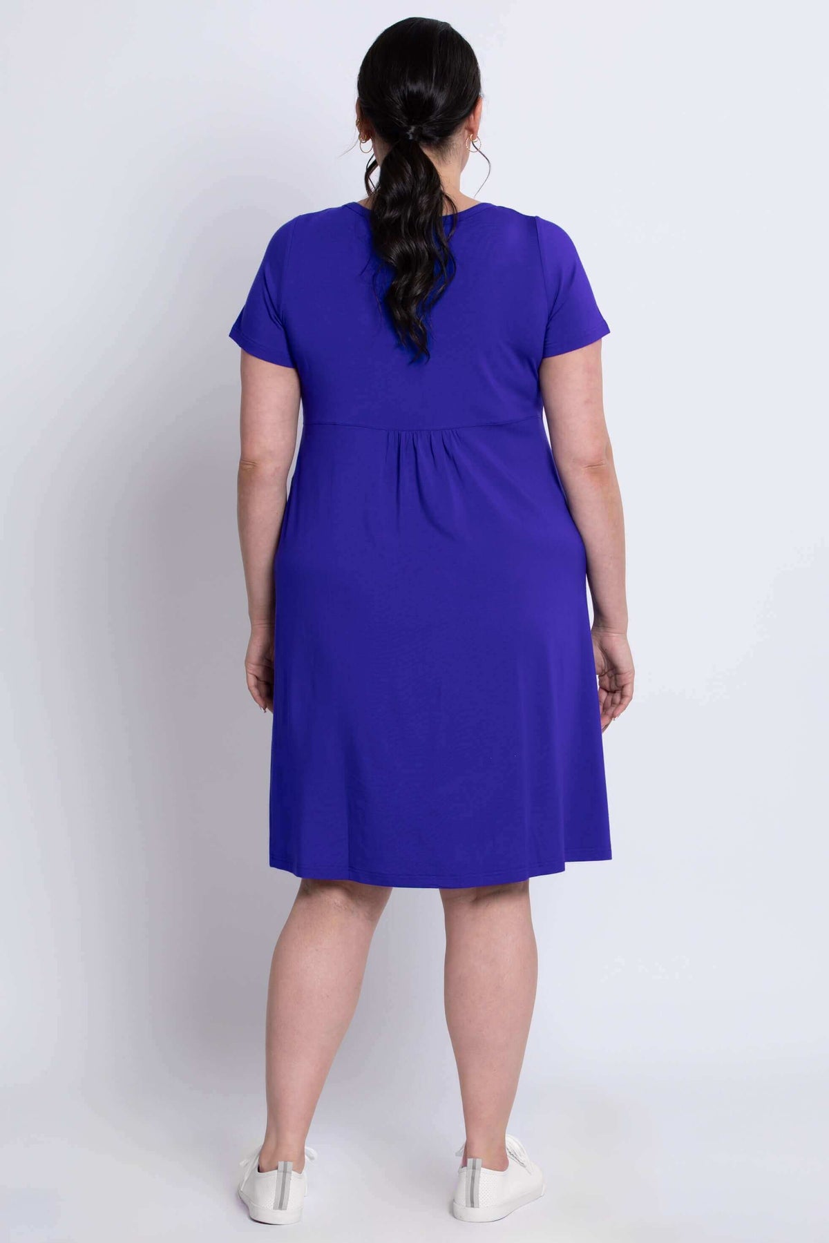 Back view of woman wearing violet bamboo dress showing relaxed fit