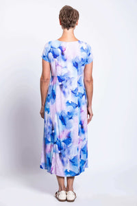 Back view of a woman in a blue and purple watercolor print midi dress