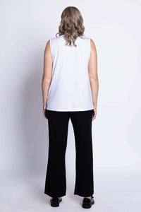 Back view of model wearing white French Terry tank top and black pants