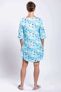 Back view of woman in blue bamboo sleepshirt with ski and mountain pattern