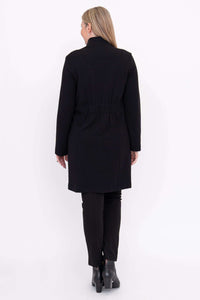 Back view of woman in black cotton mid-length coat with elastic waist detail