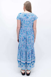 Back view of woman in blue floral Sharpie Dress showing tiered skirt detail