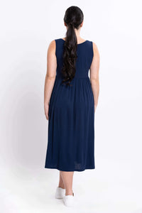 Back view of woman in indigo sleeveless midi dress showing skirt flow