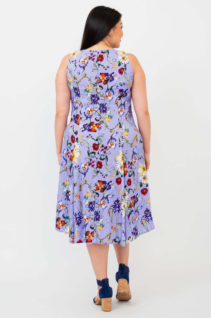 Back view of a woman in a sleeveless lilac floral A-line dress with flared skirt
