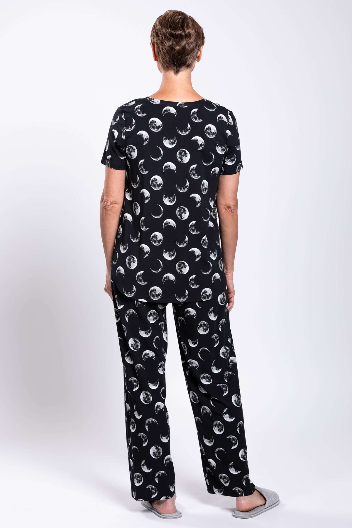Back view of woman wearing black moon phase printed top and pants