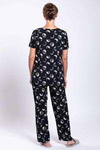 Back view of woman wearing black moon phase printed top and pants