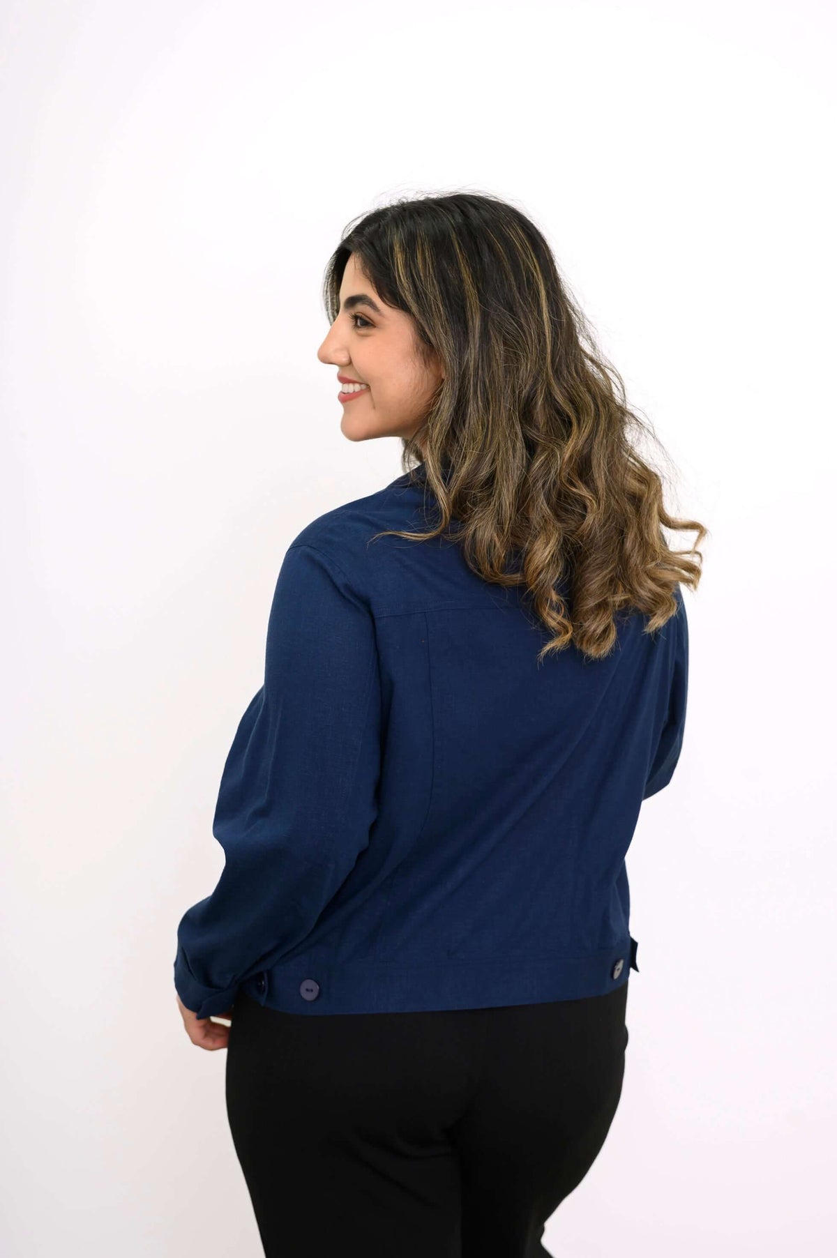 Rear view of woman wearing a navy blue collared jacket