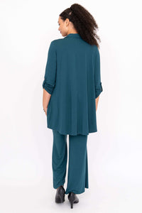 Back view of woman in teal wide leg pants and matching shirt
