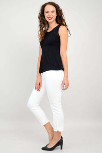 Back view of woman wearing black tank top with mesh panel and white pants