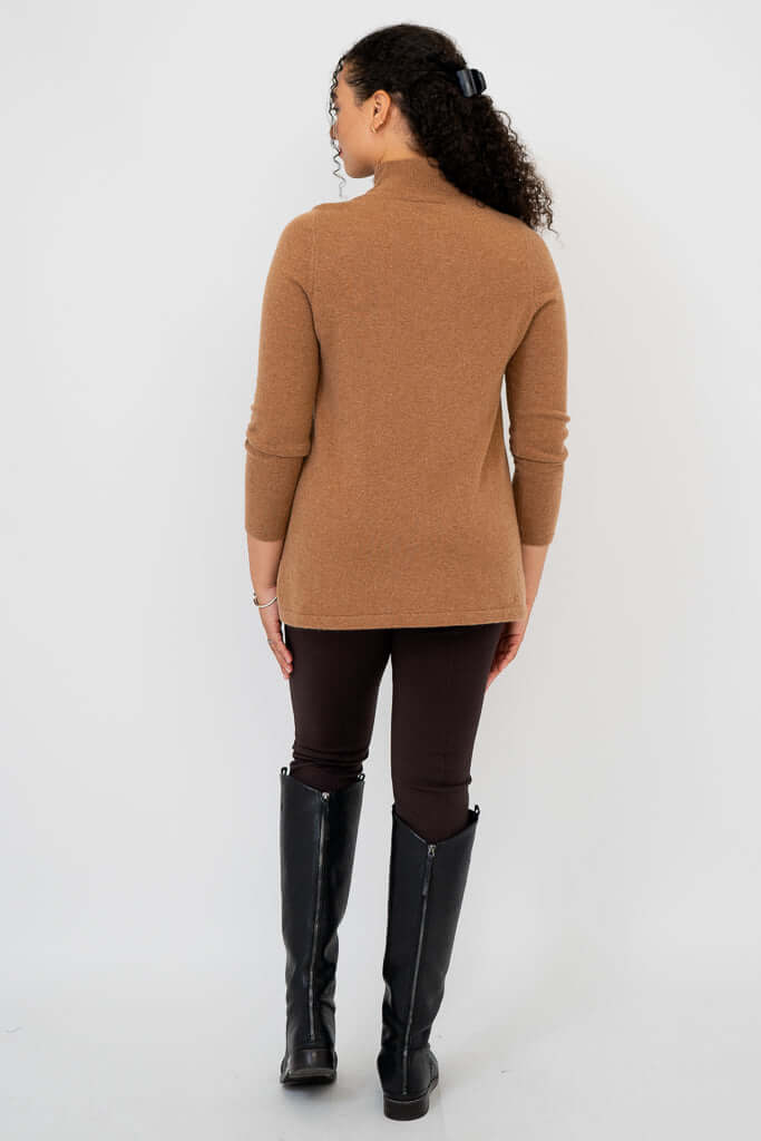 Back view of woman wearing camel brown mock neck sweater