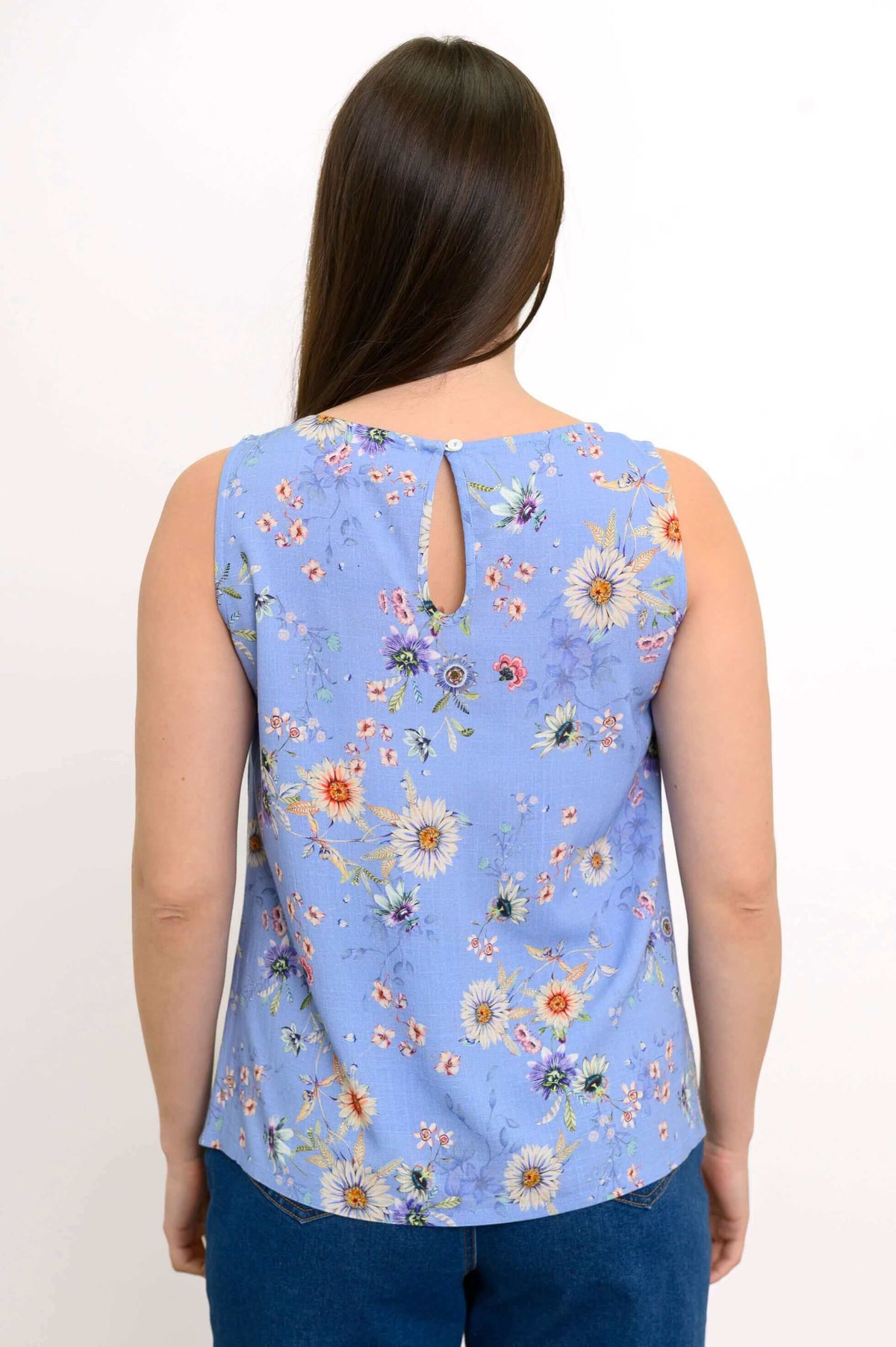Back view of a woman wearing the blue floral tank top with a button closure