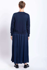 Back view showing navy Roma tiered maxi skirt and sweater, hands by sides