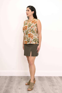 Woman showing the back of sleeveless floral tank top and olive skirt