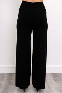 Rear view of a model in black straight-leg trousers, showcasing a comfortable mid-hip rise and fluid fall.