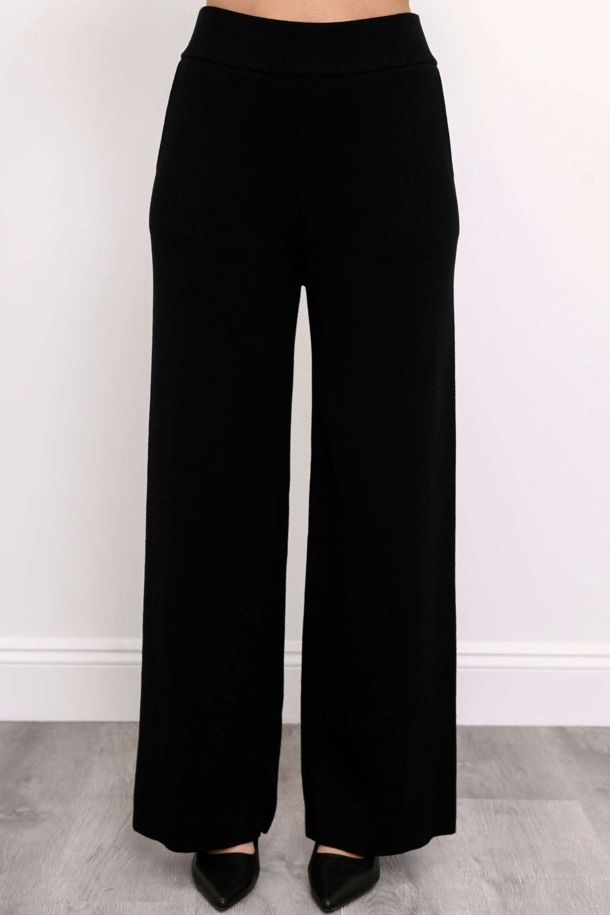 Comfortable onyx-colored pull-on pants showing side seam pockets and a fluid drape, shown on a white background.