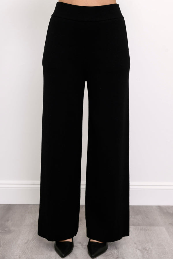 Comfortable onyx-colored pull-on pants showing side seam pockets and a fluid drape, shown on a white background.