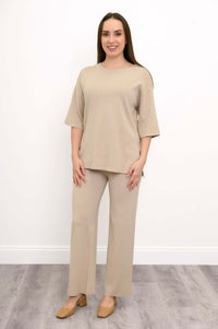 Front view of a woman wearing the beige Bailey Sweater.