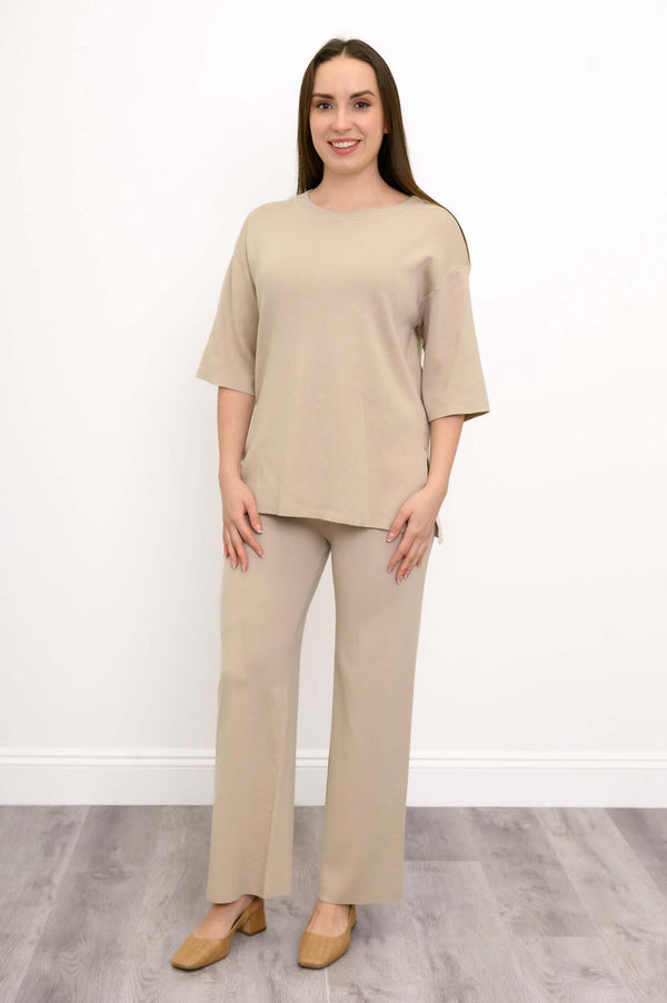 Front view of a woman wearing the beige Bailey Sweater.