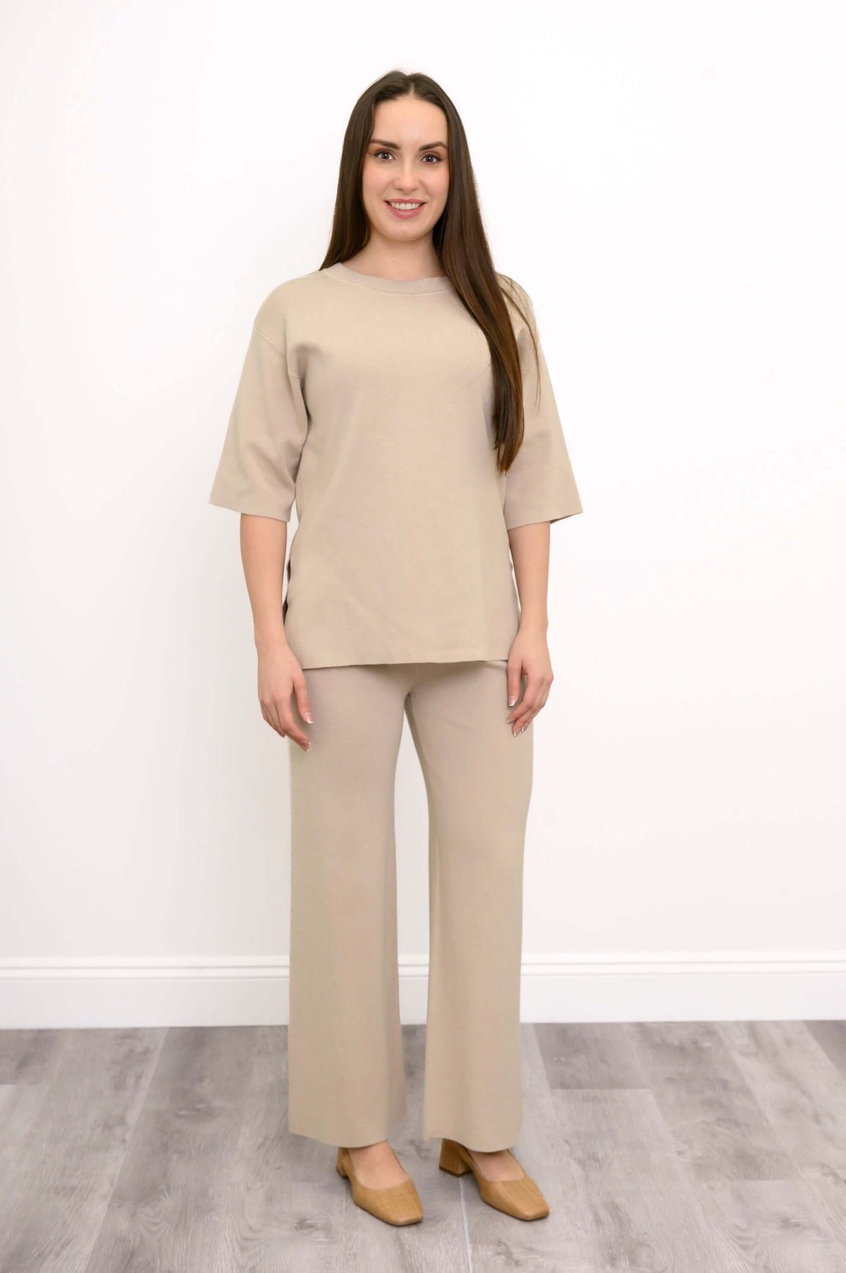Side view of a woman in the beige short sleeve Bailey Sweater