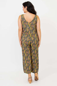 Rear view of model in sleeveless bamboo linen floral jumpsuit with V-back