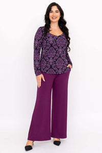 Full body front view of model in purple damask top and matching purple pants