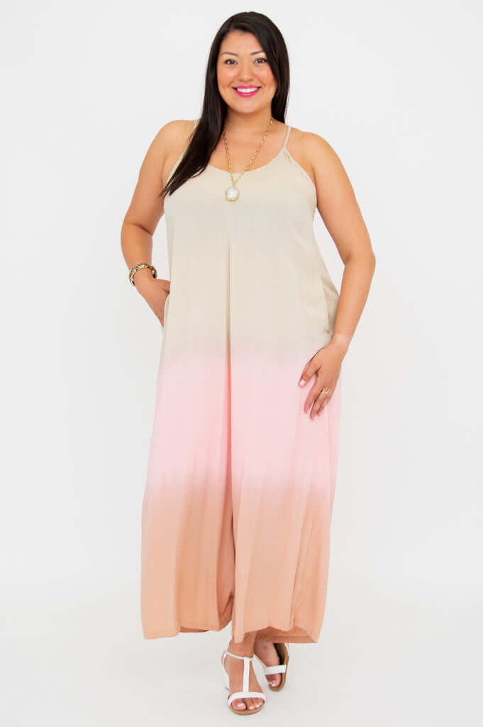 Model standing with relaxed pose in an ombre jumpsuit with wide legs and pockets