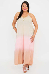 Model standing with relaxed pose in an ombre jumpsuit with wide legs and pockets