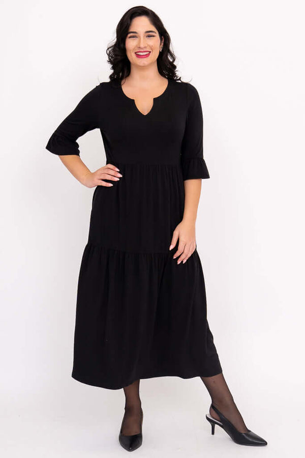 Woman posing in black Bernadette Long Dress with hand on hip
