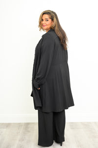 Back view of a structured black long sleeve tunic top showing a clean paneled finish across the midsection.