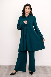 Wide studio shot of a relaxed-fit teal bamboo tunic featuring an empire waistline and paneled skirt.